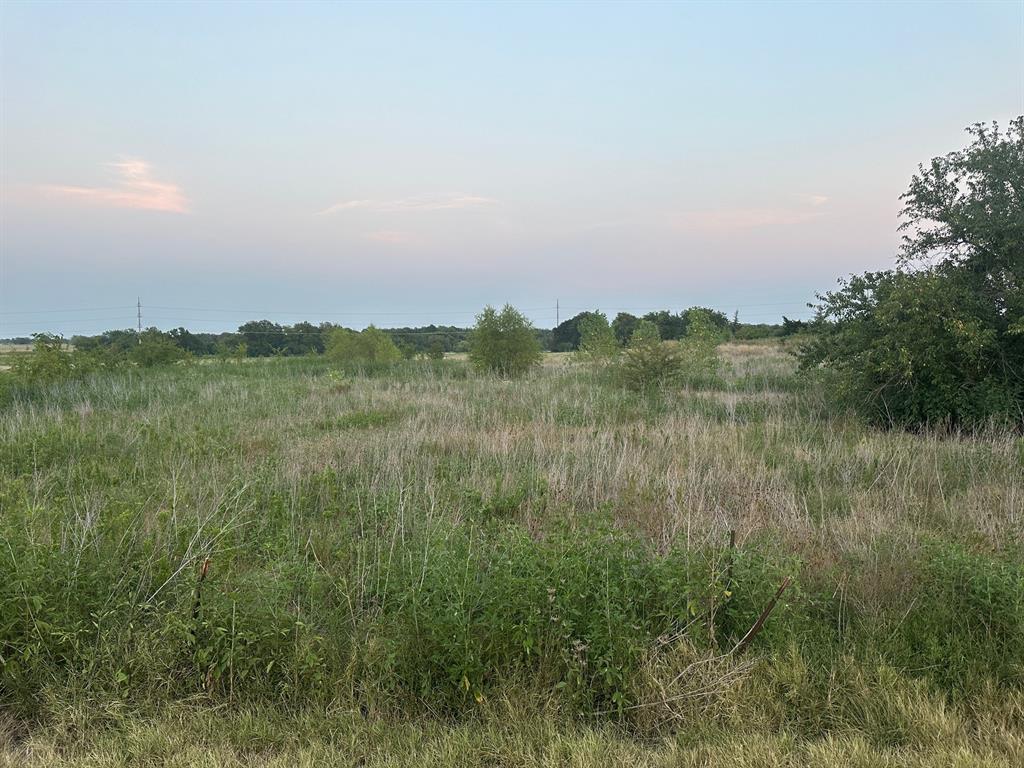 a view of a lake and green valley