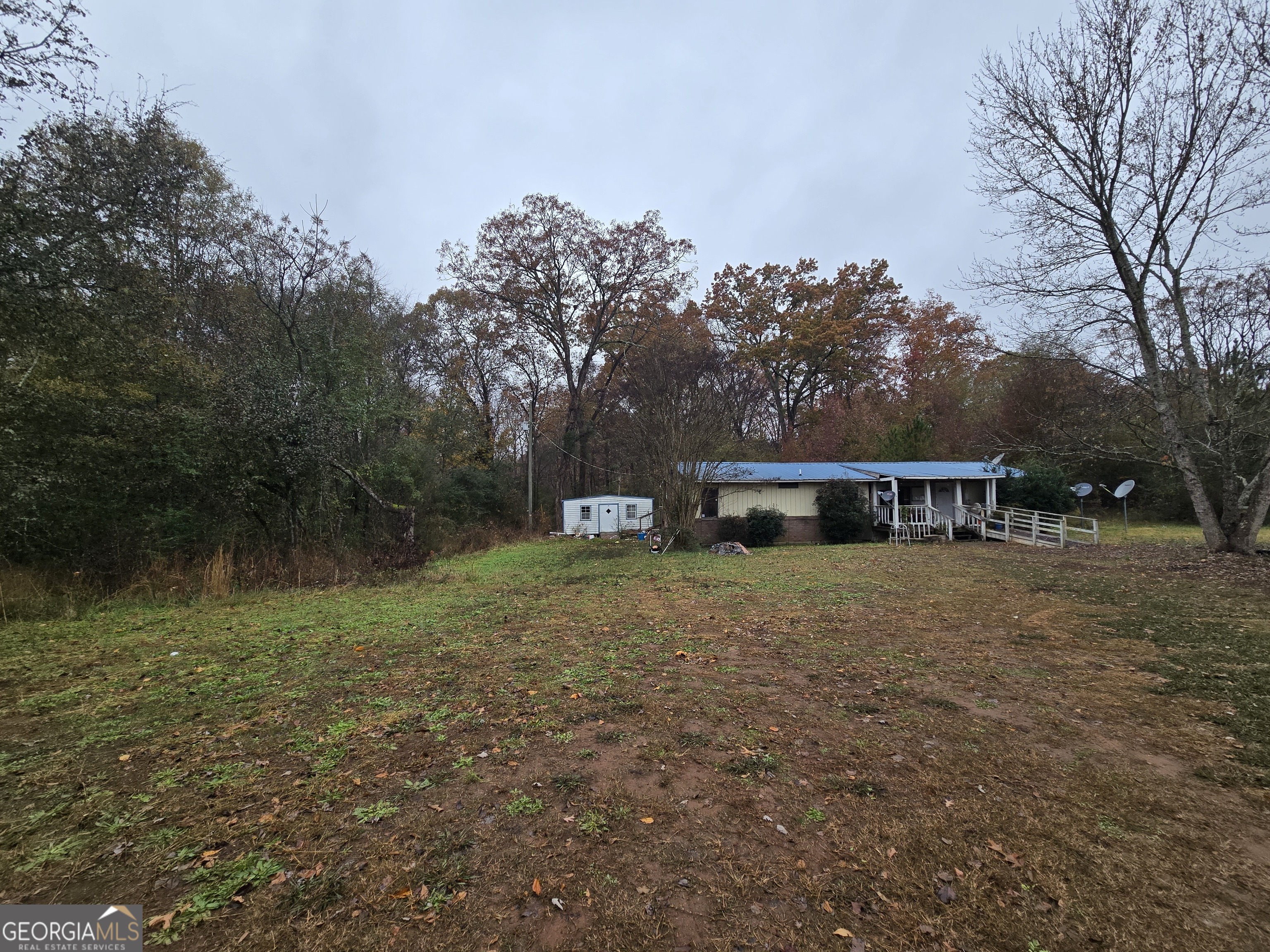 a front view of a house with a yard and trees