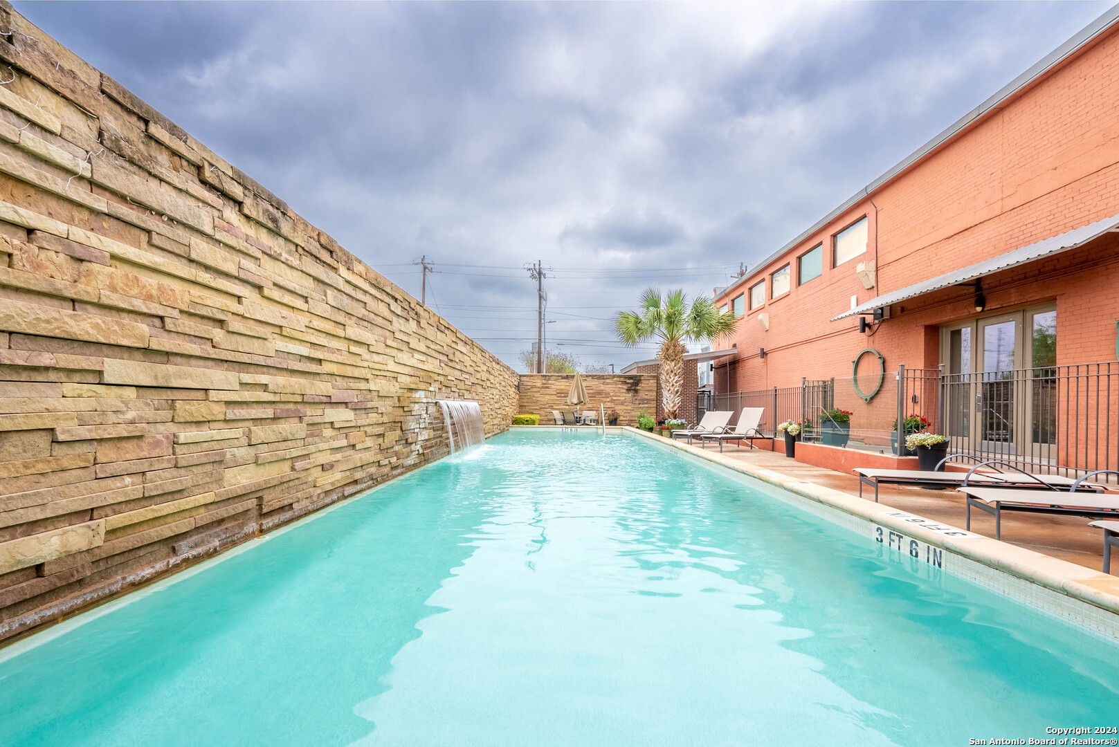 a view of swimming pool with a patio