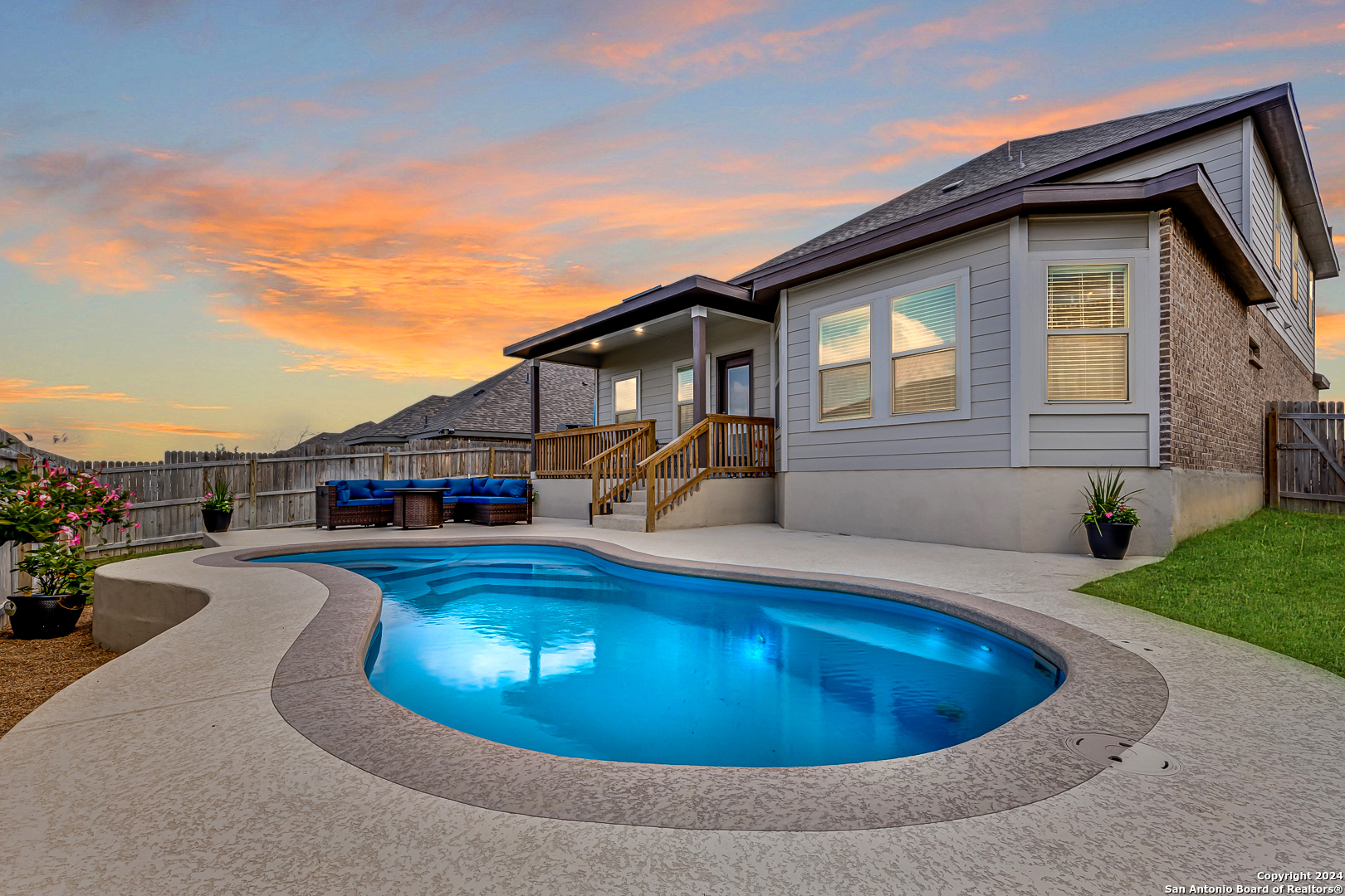 a view of a house with swimming pool and porch