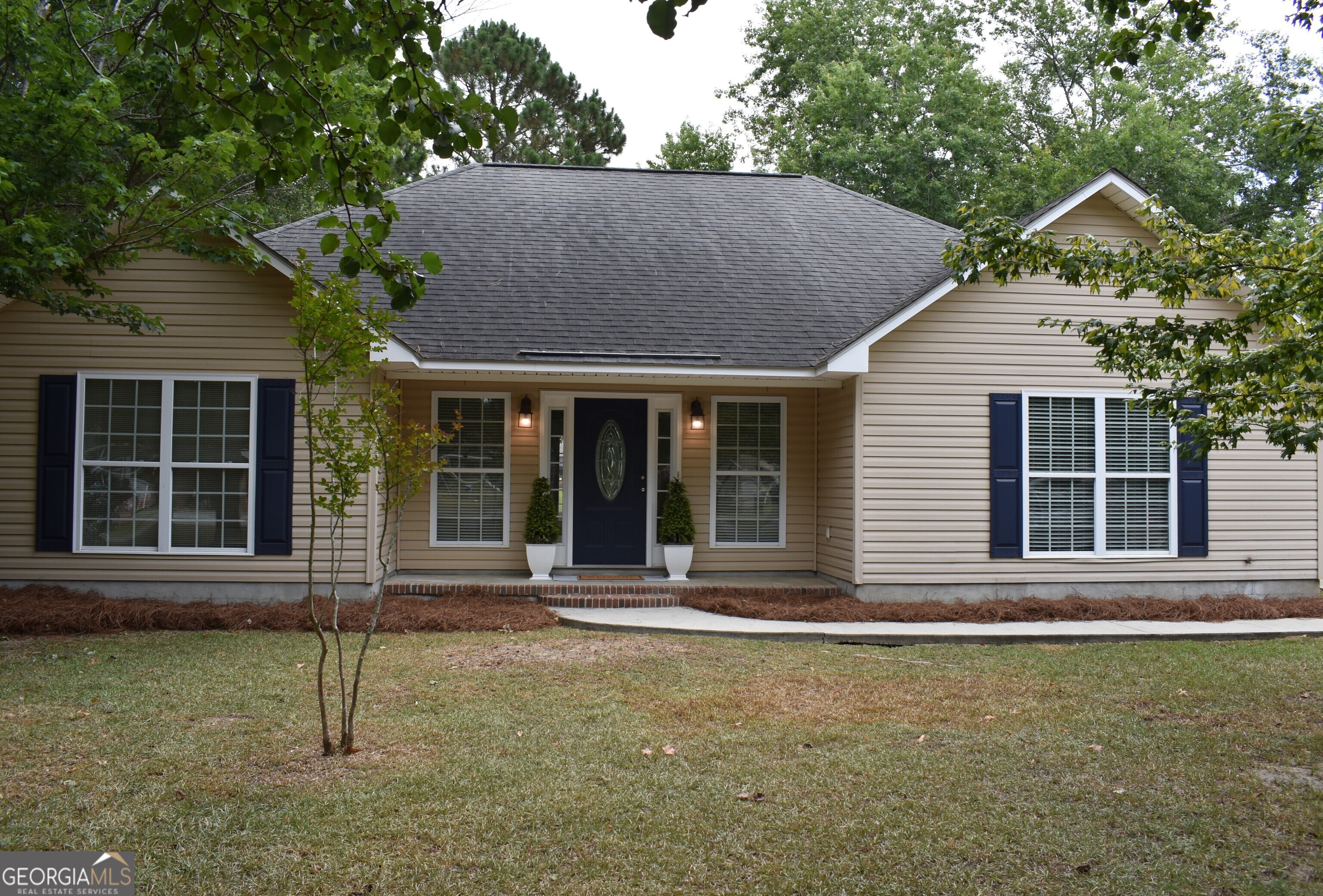 a house with trees in the background