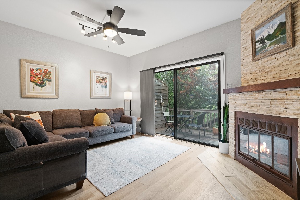 a living room with furniture a fireplace and a flat screen tv