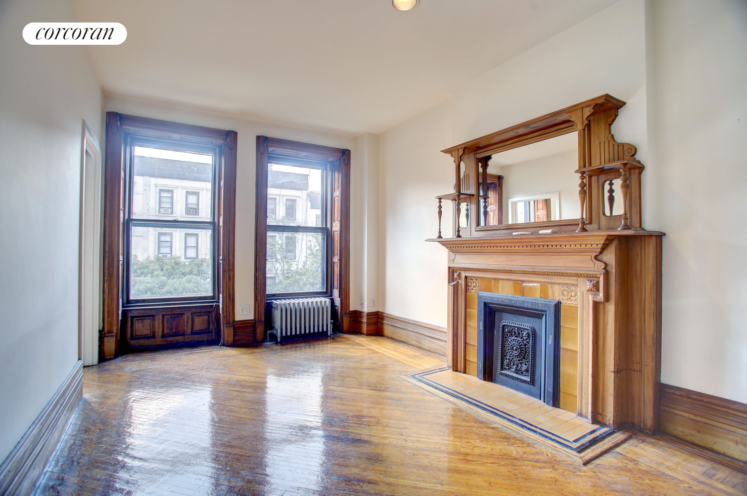 a view of an empty room with window and fireplace