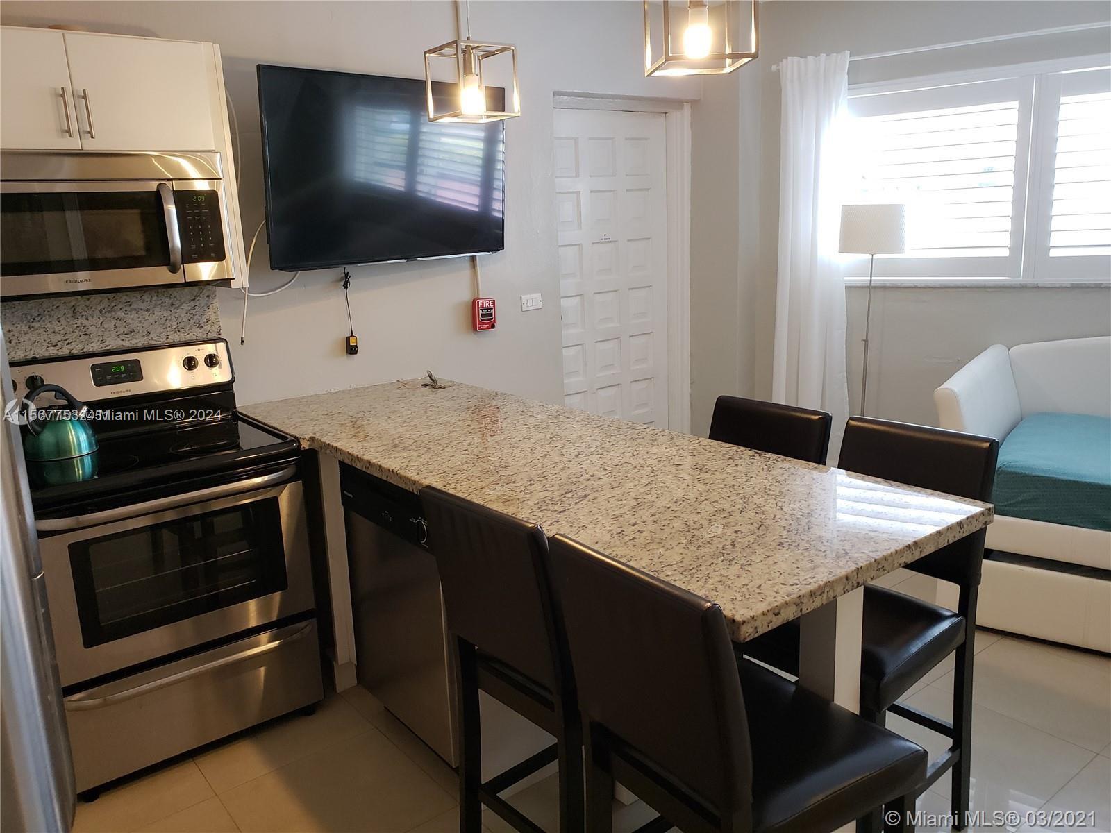 a kitchen with a stove a sink and a microwave