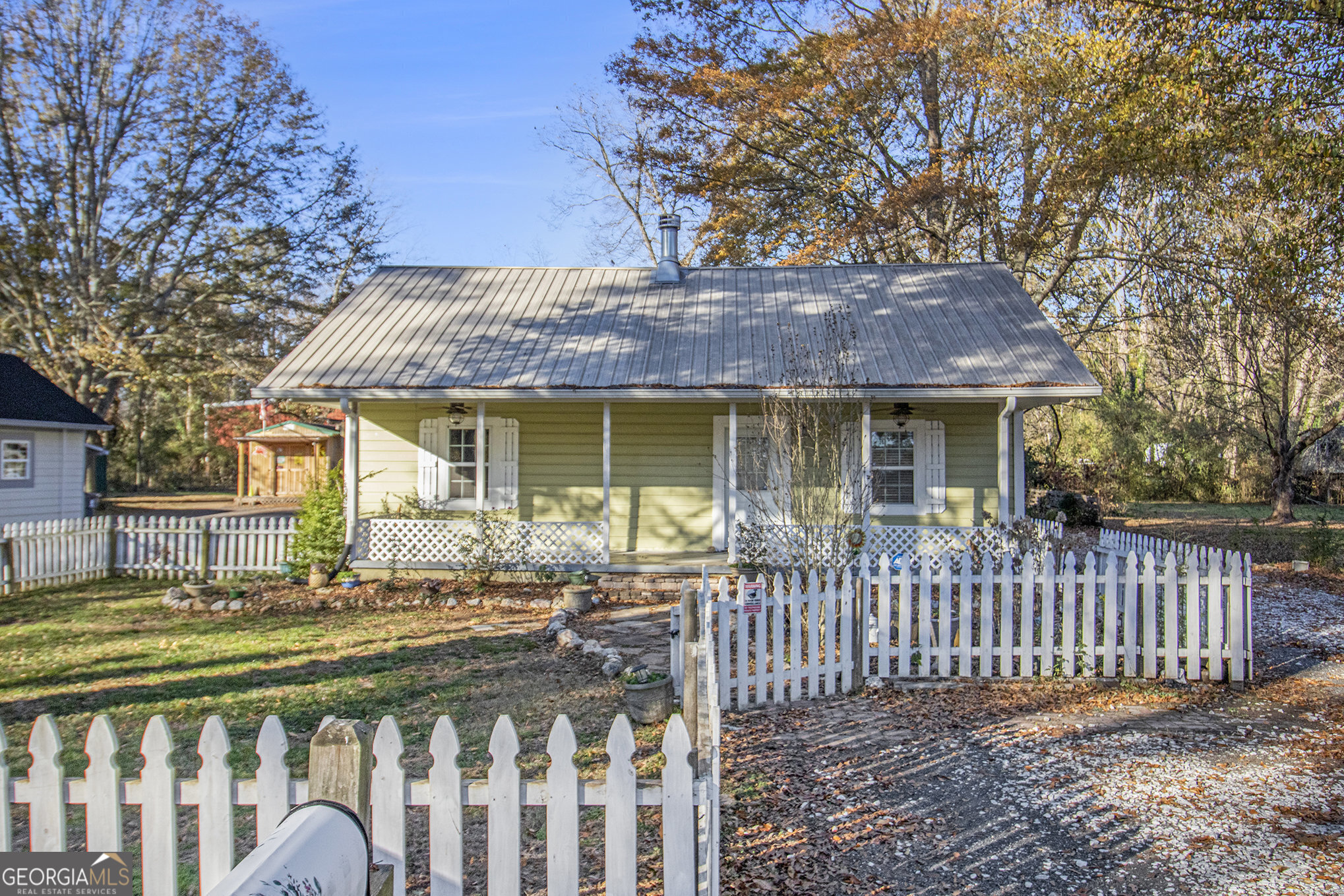 a front view of a house with a garden