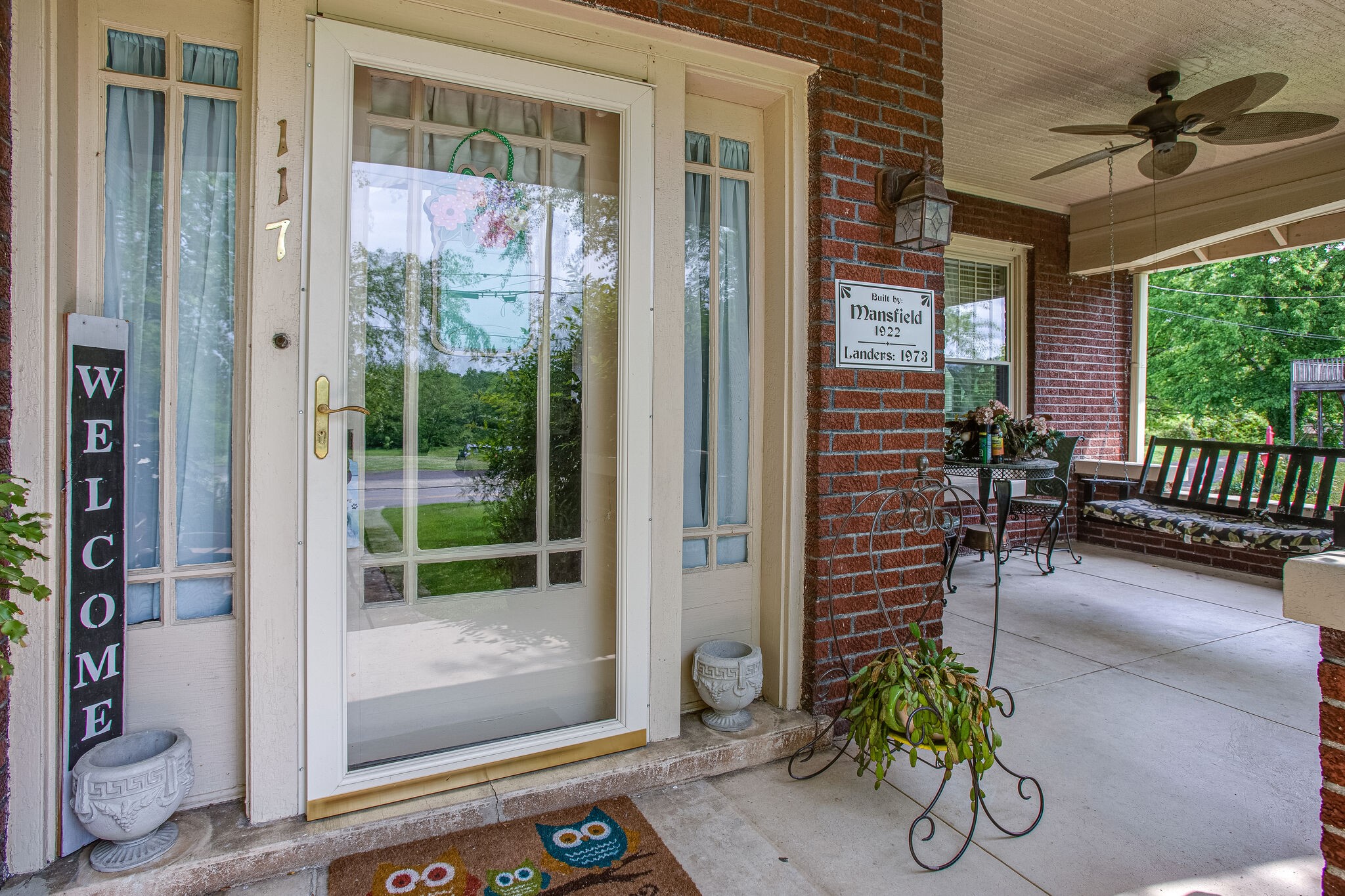 a view of a porch with chairs and potted plants