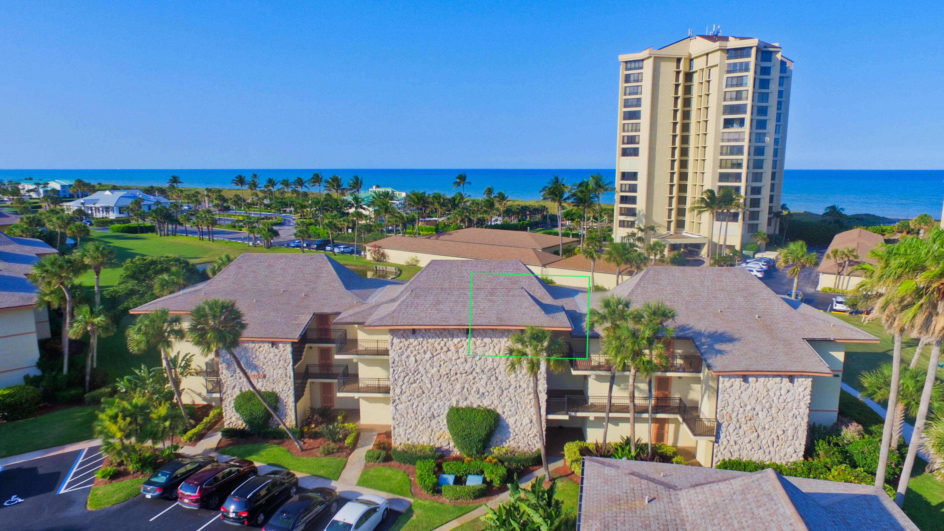 an aerial view of multiple houses with a yard