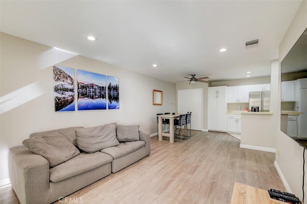 a living room with furniture and kitchen view