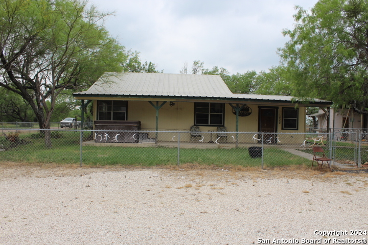 a front view of house with deck and yard