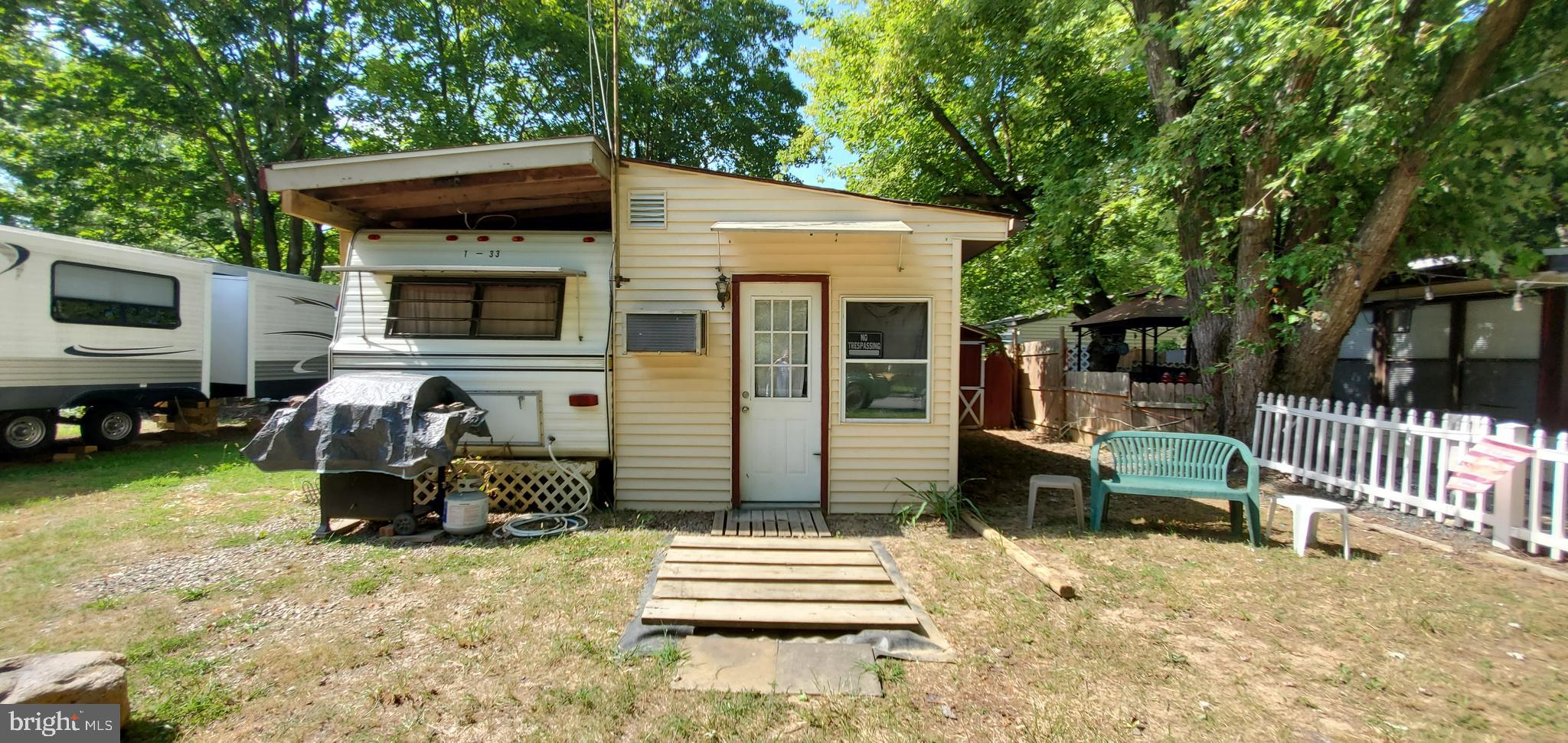 a backyard of a house with barbeque oven and outdoor seating