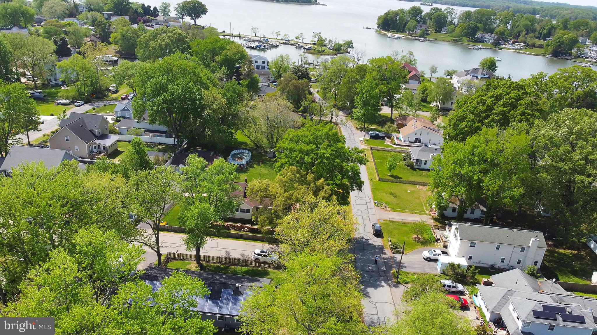 an aerial view of a house with outdoor space and lake view