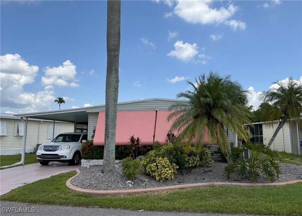 a view of house with outdoor space and car parked