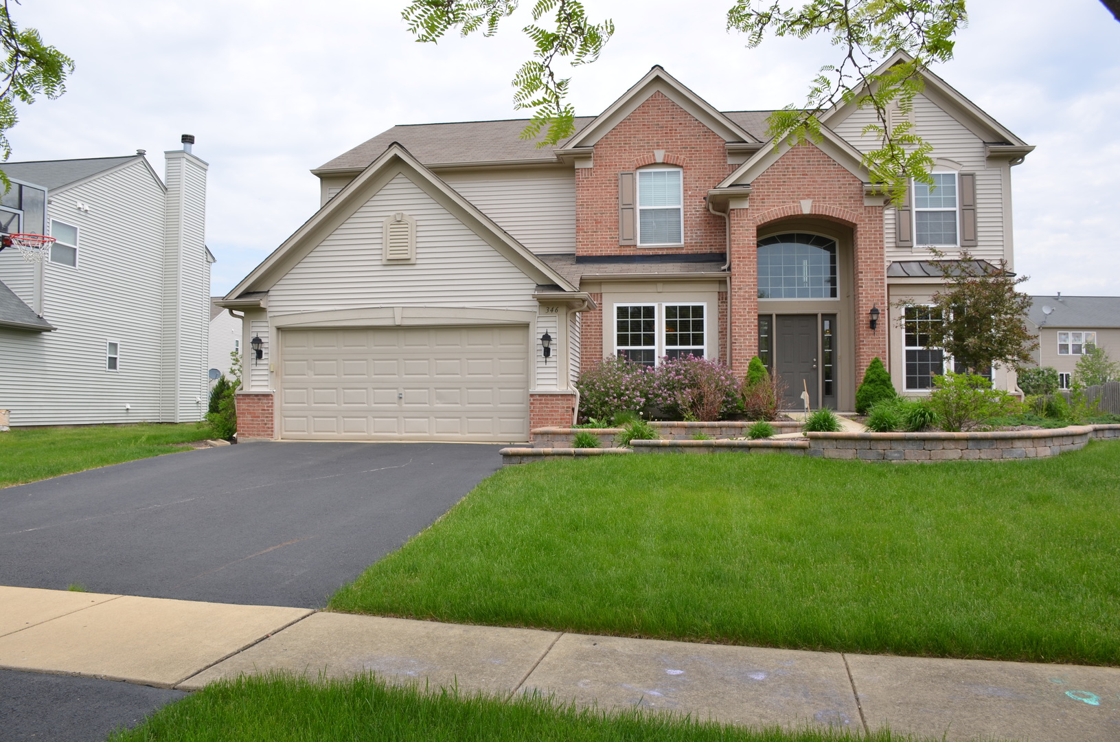 a front view of a house with a yard and garage