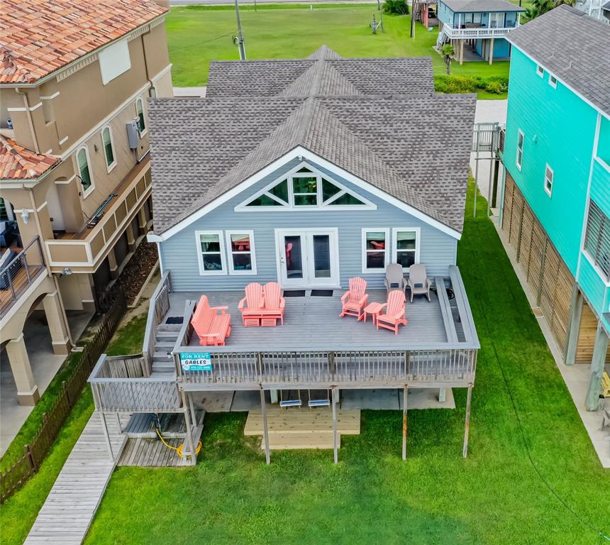 an aerial view of a house with a yard table and chairs