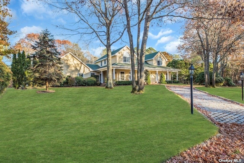 a view of house with a backyard