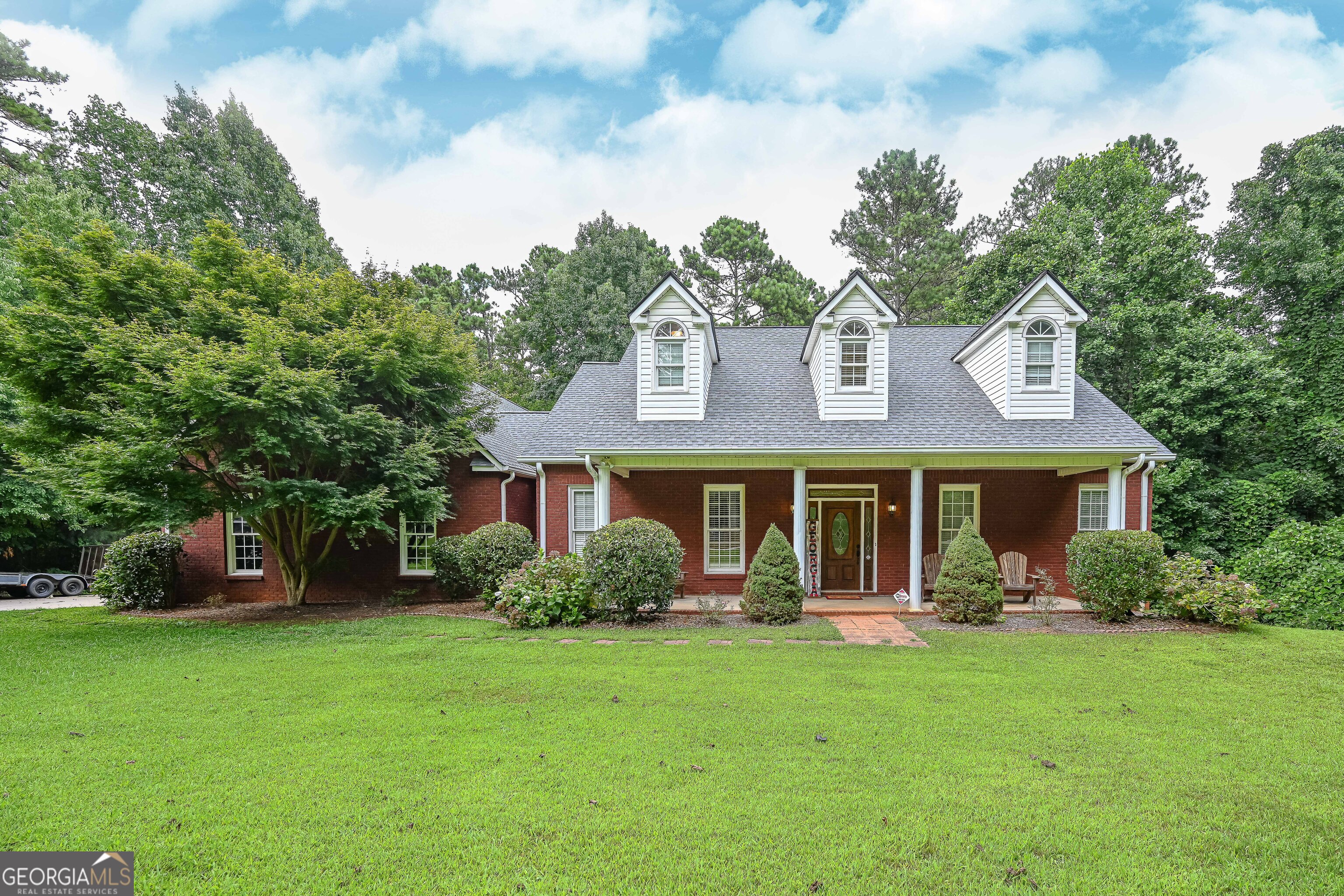 a front view of a house with garden