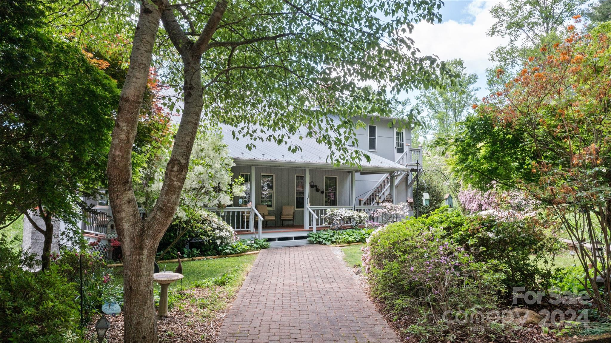 a front view of a house with a garden