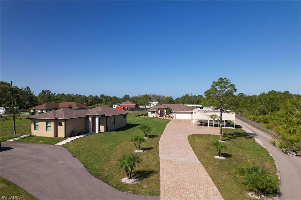 a view of a house with a yard and a wooden fence