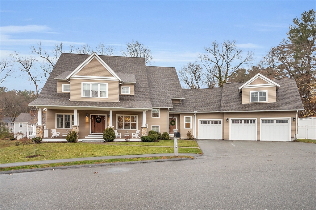 a front view of residential houses with yard and trees