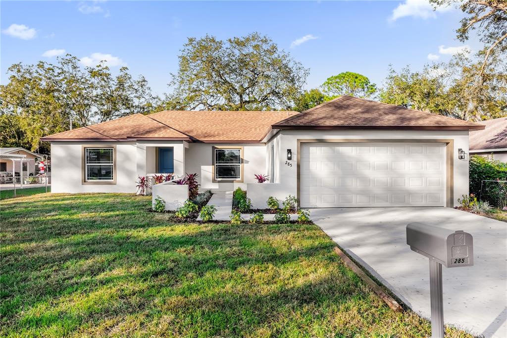 a front view of a house with a yard and garage