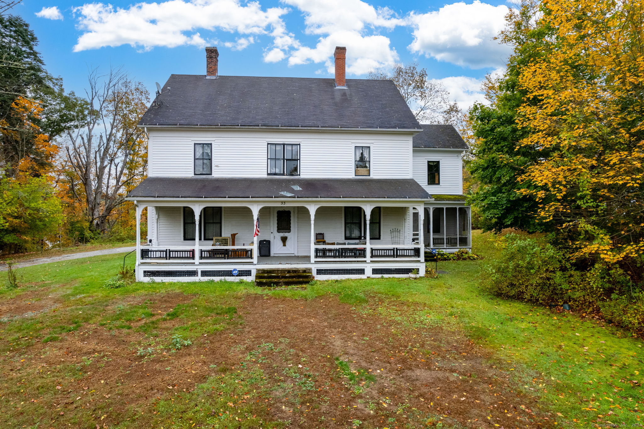 a front view of a house with a garden and sitting area