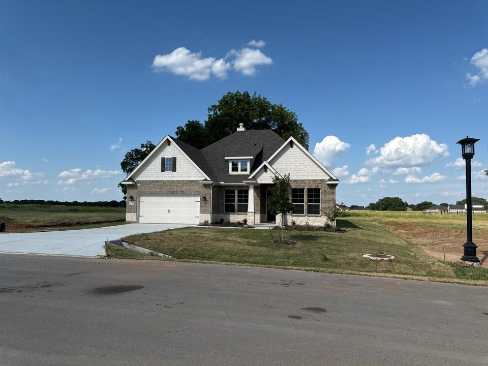 a front view of a house with a yard and ocean view