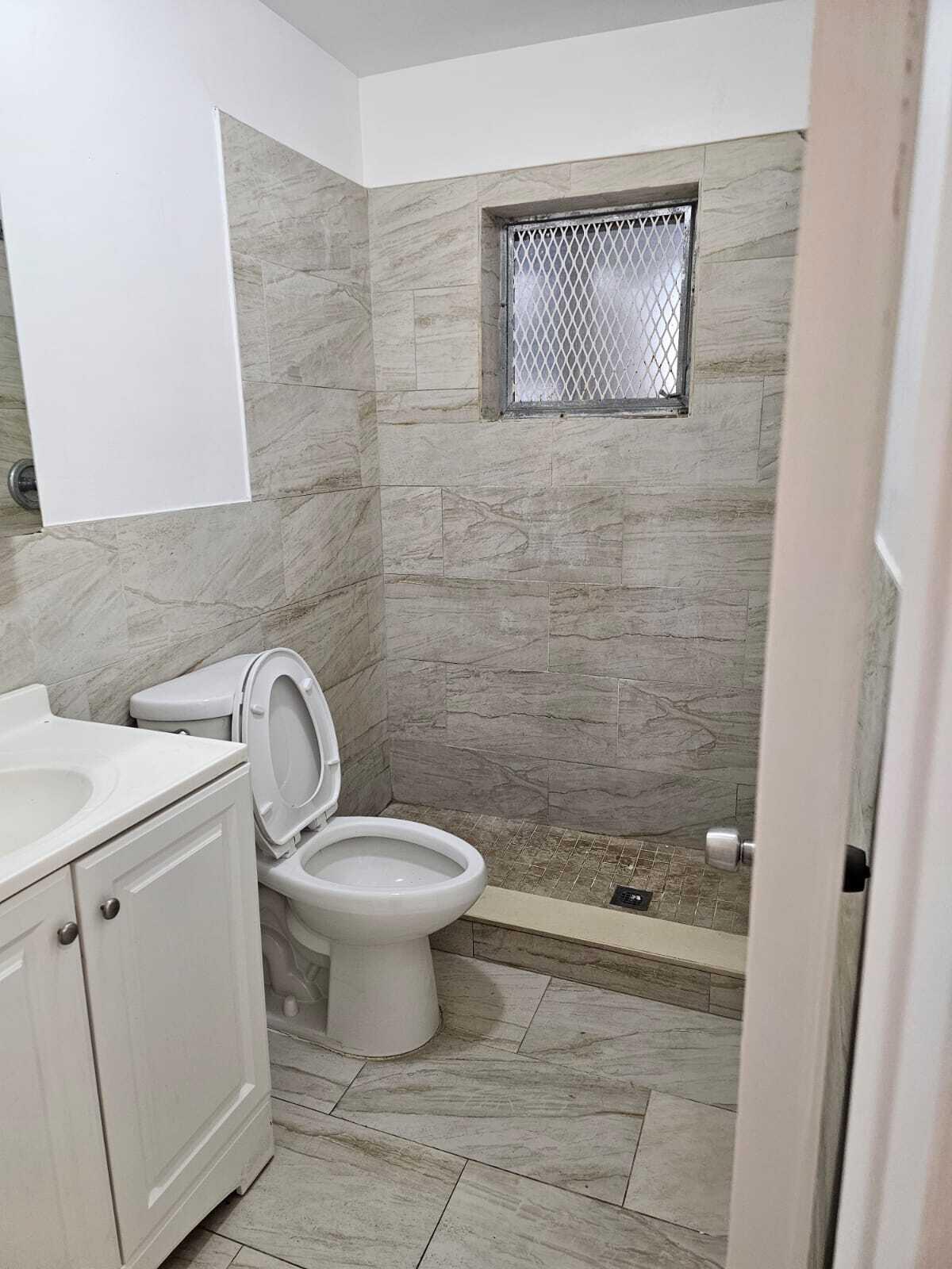 a bathroom with a toilet sink and shower