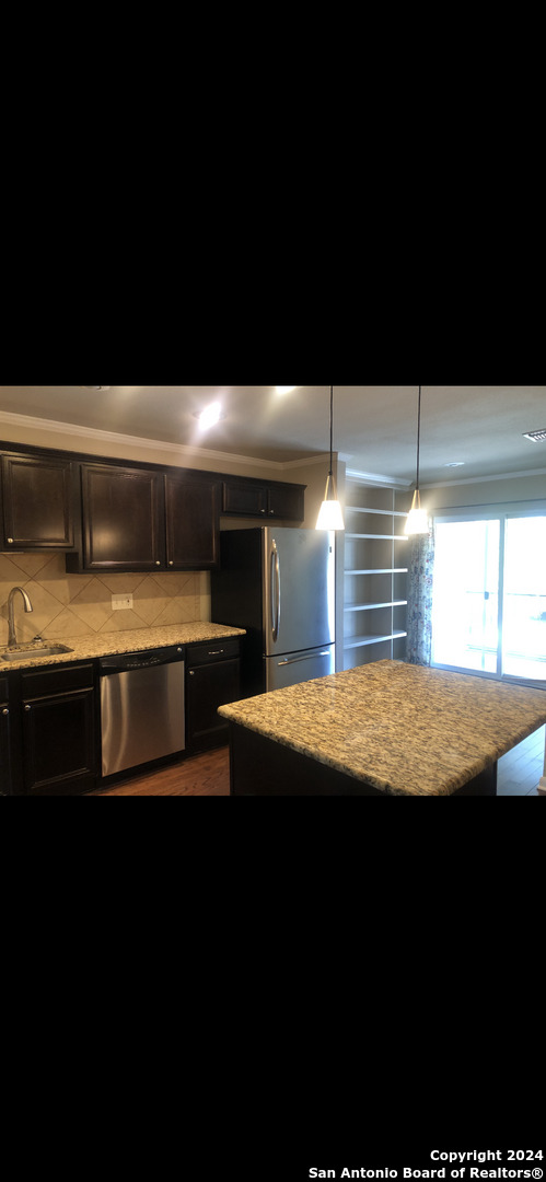 a view of outdoor kitchen with kitchen island