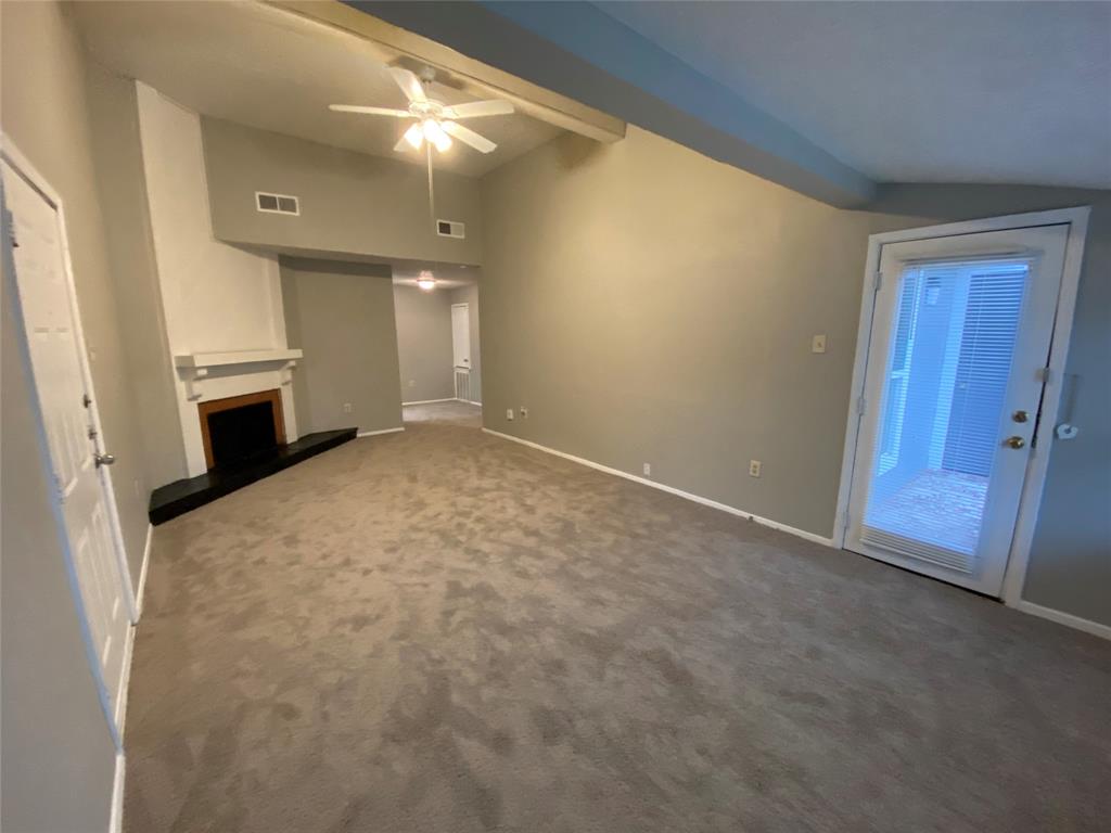 a view of an empty room with a fireplace