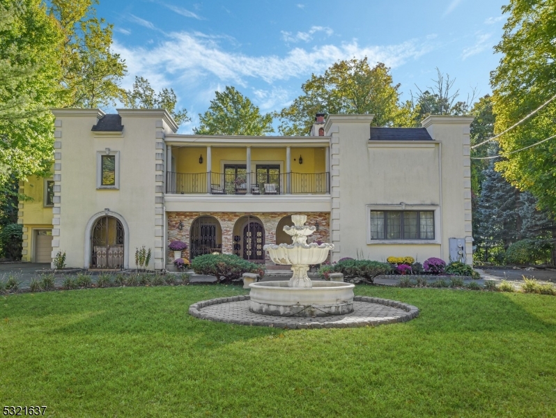 a front view of a house with a garden and plants