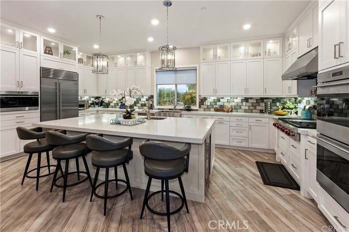 a kitchen with stainless steel appliances kitchen island granite countertop a sink and cabinets