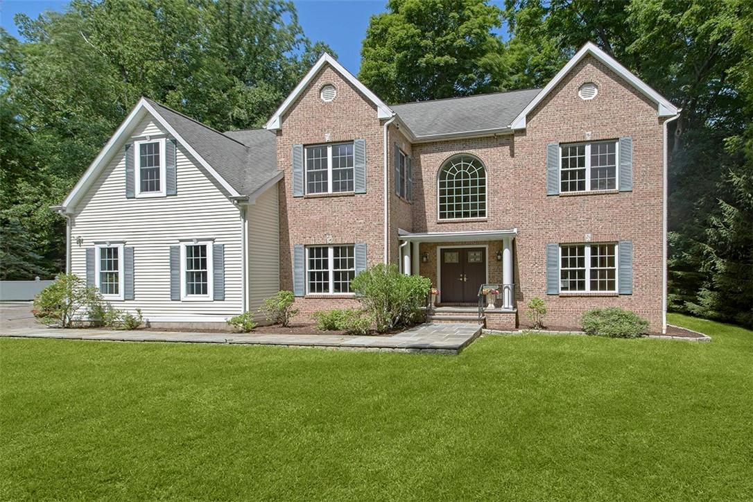 a front view of a house with a yard and porch