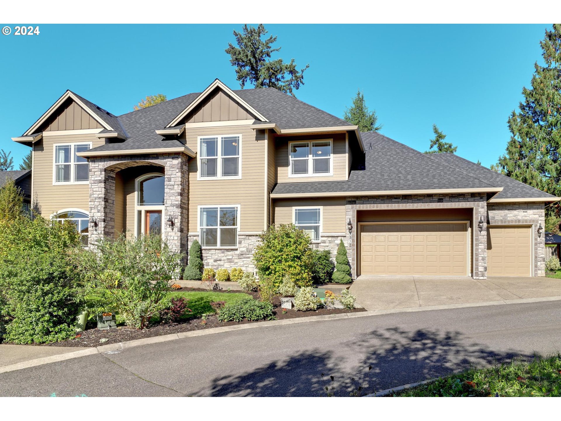 a front view of a house with a yard and garage