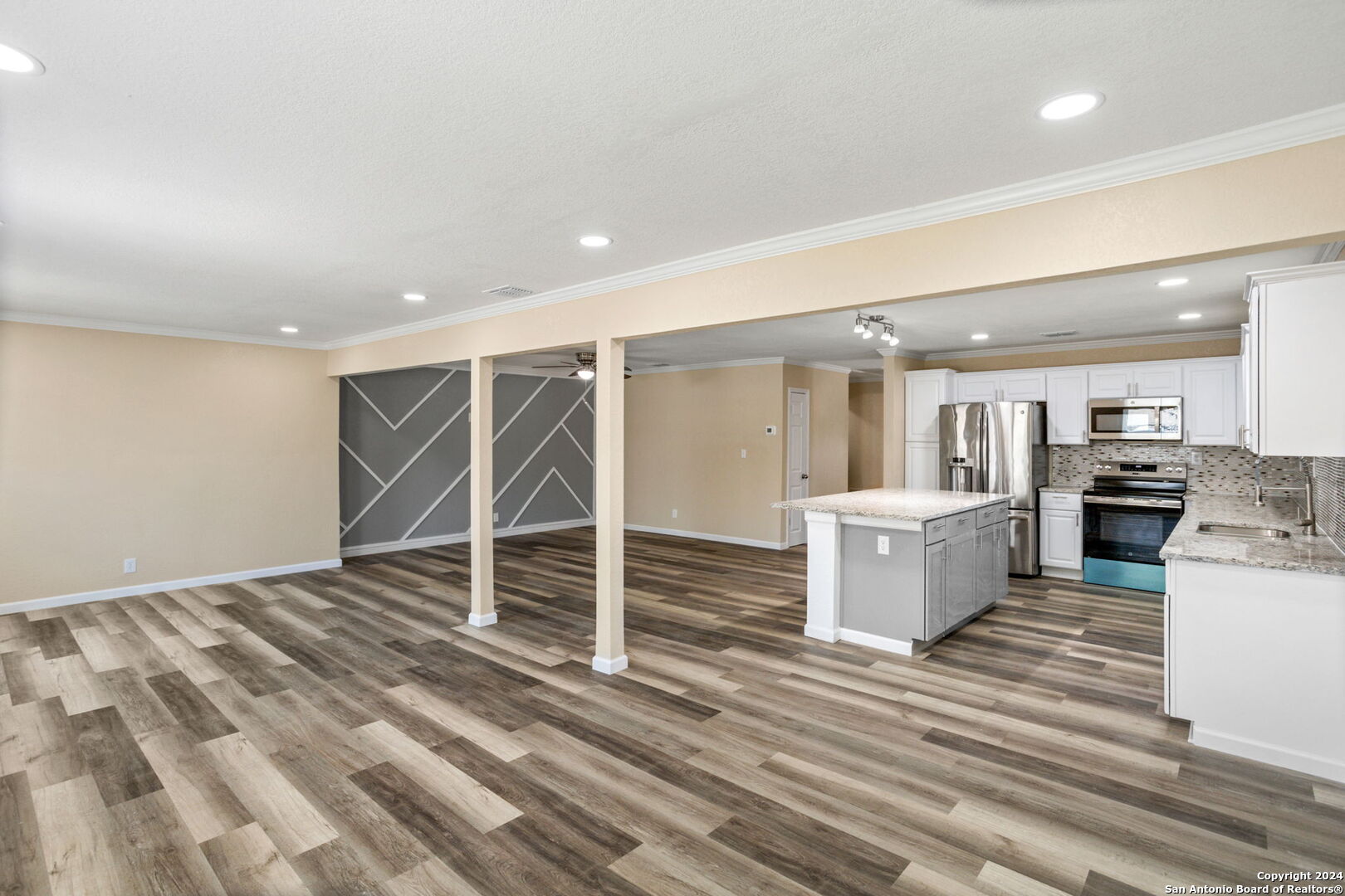 a view of a kitchen with wooden floor and a sink