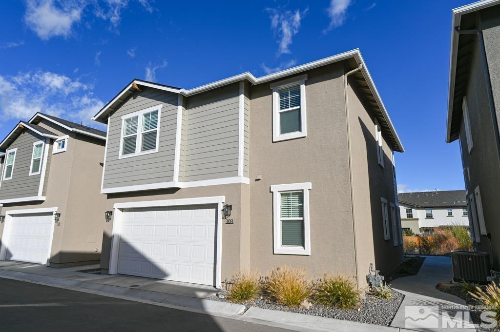 a front view of a house with garage