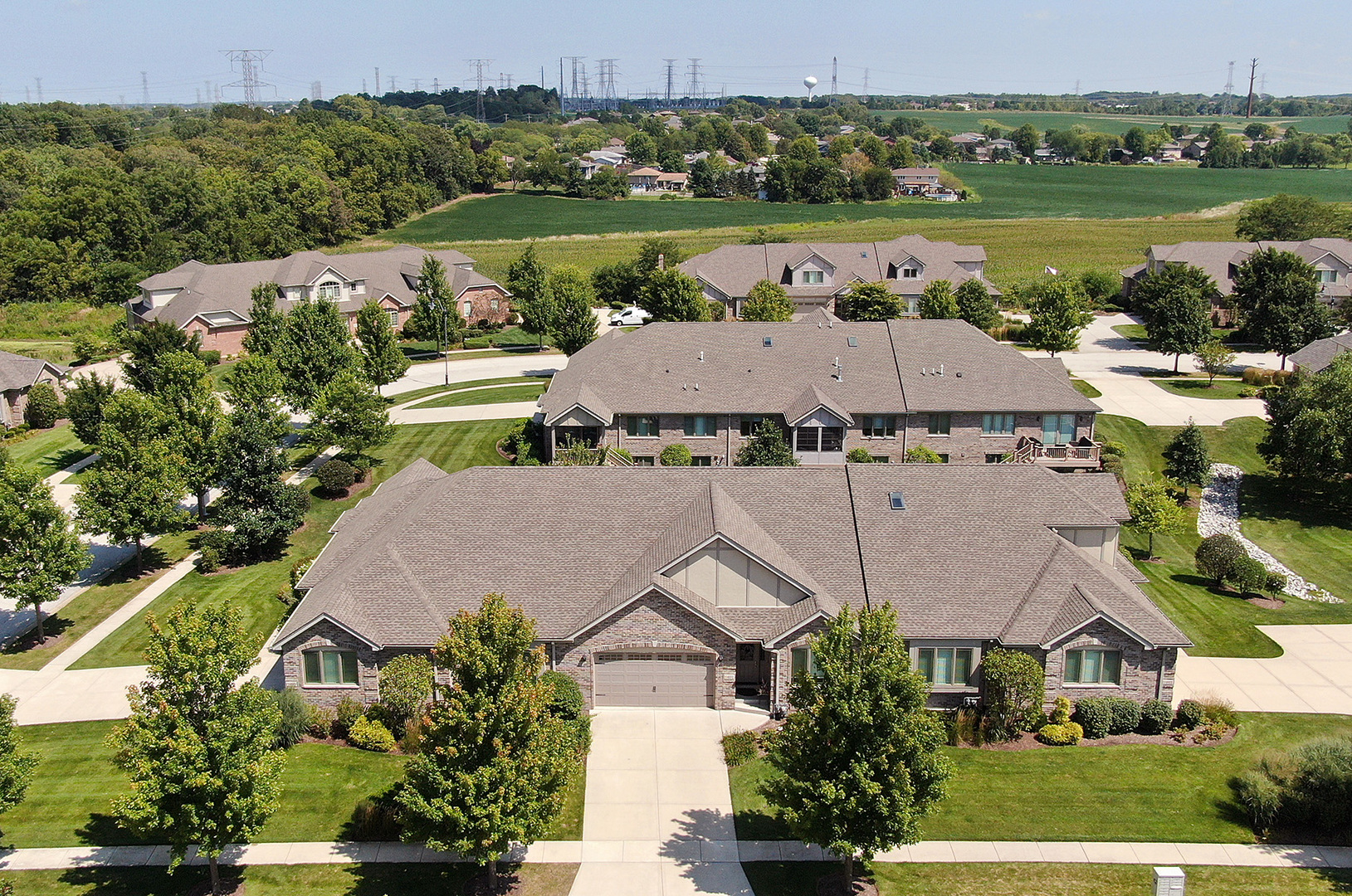 an aerial view of a house with a garden and lake view