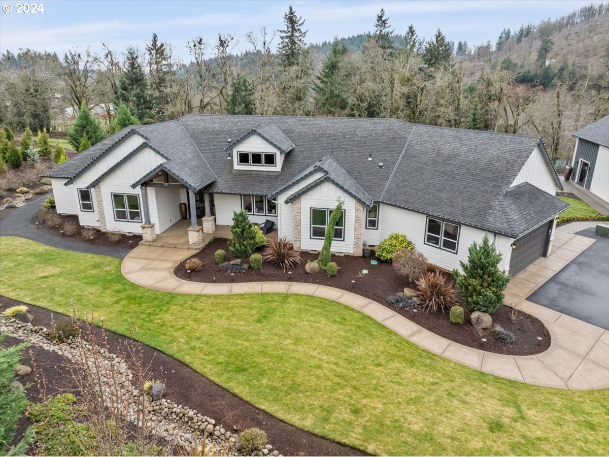 a aerial view of a house with swimming pool and a yard