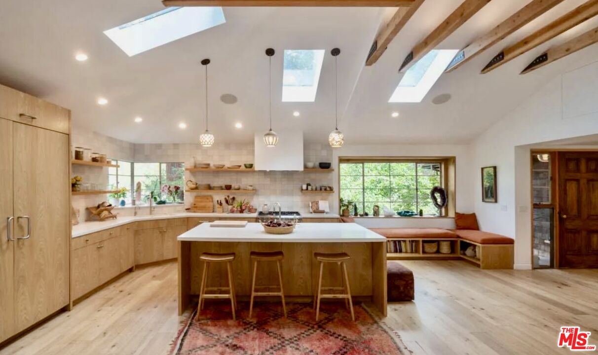 a kitchen with a table chairs stove and cabinets