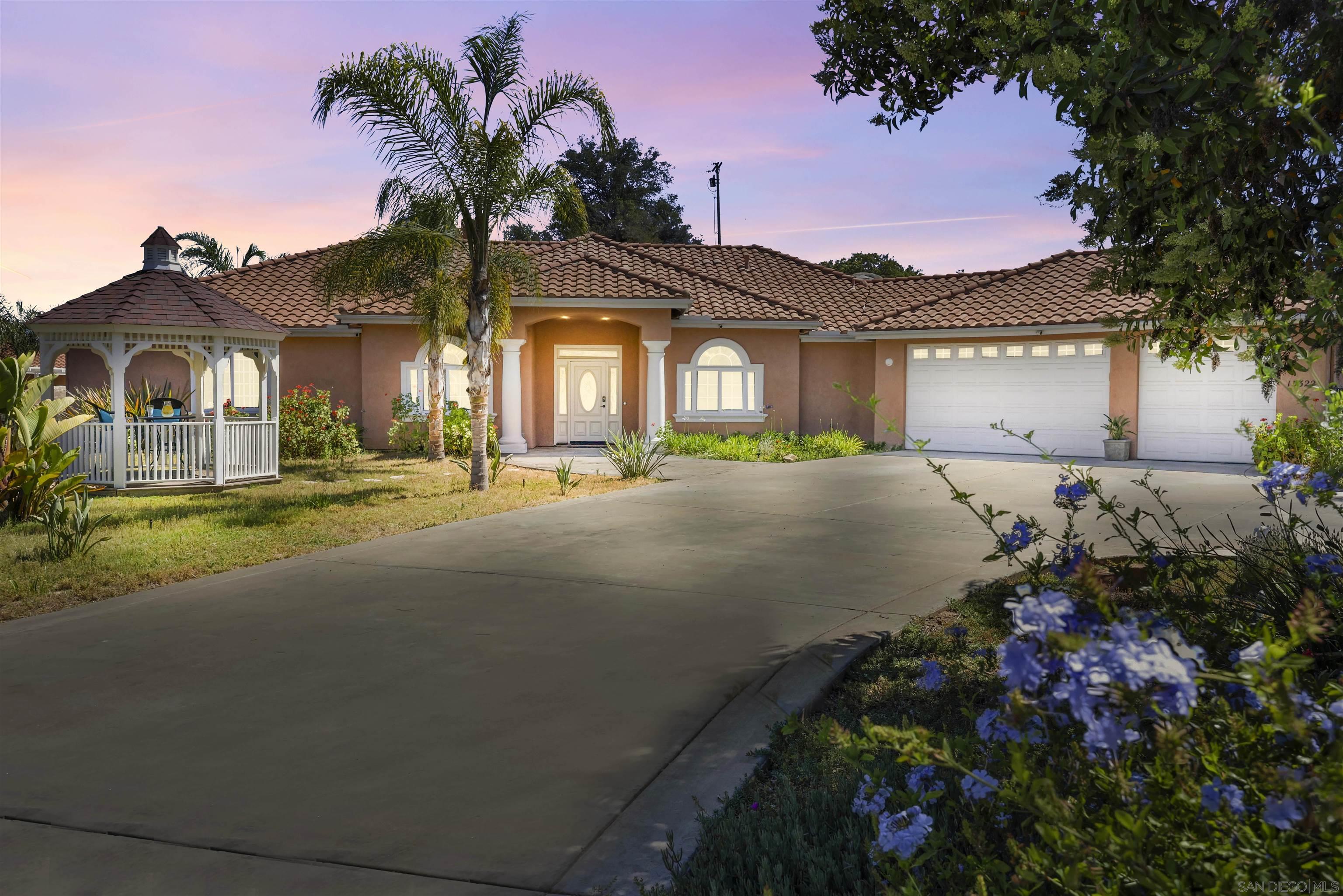 a front view of a house with a yard and outdoor seating