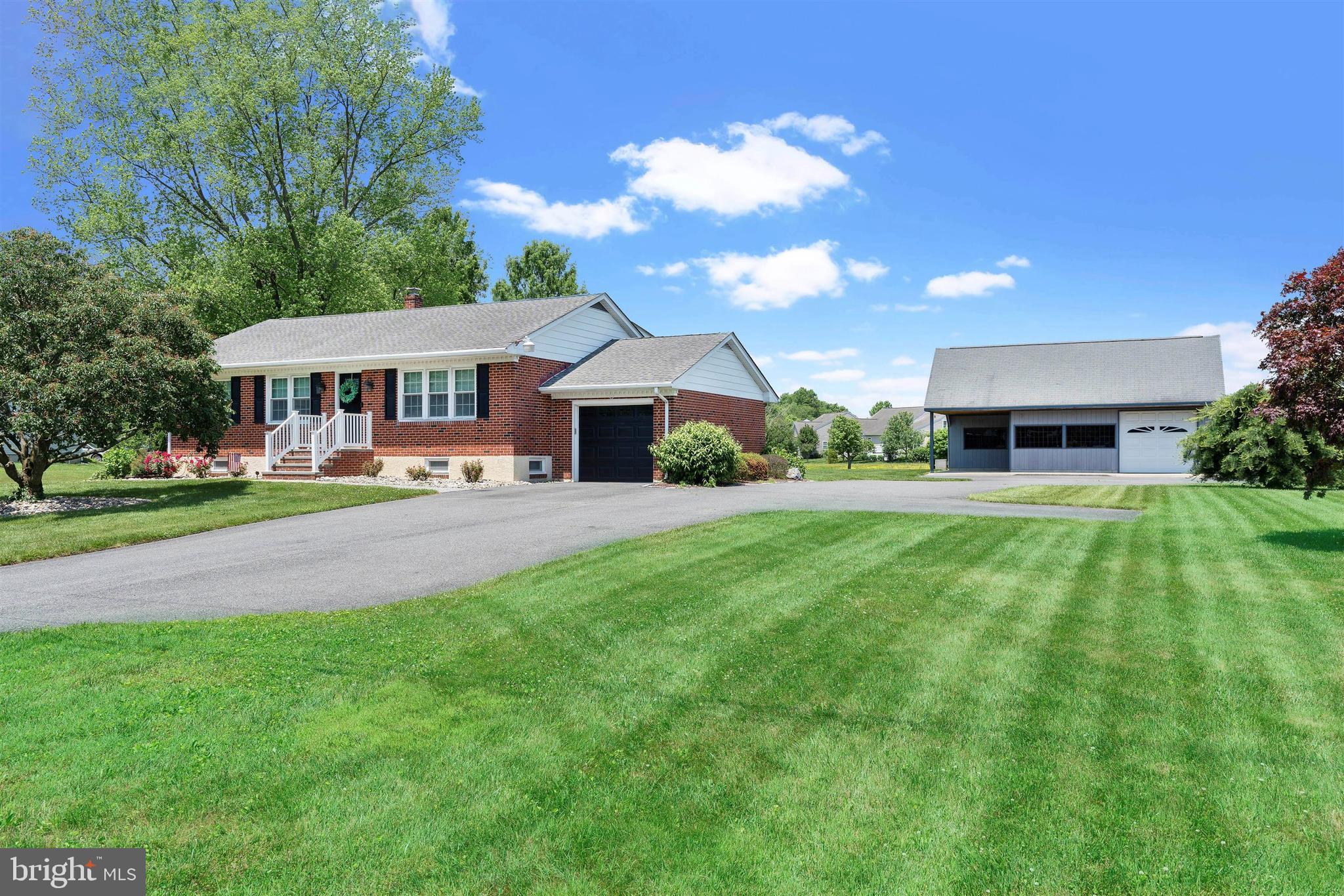 a front view of house with yard and green space