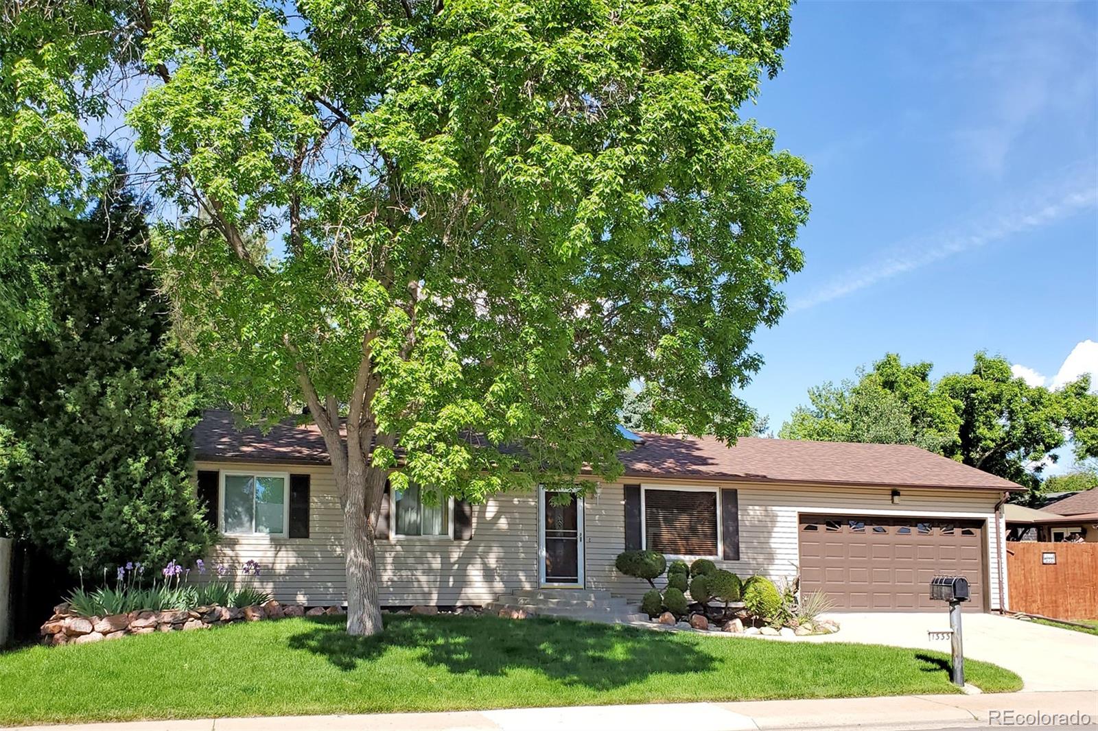 a front view of house with a garden