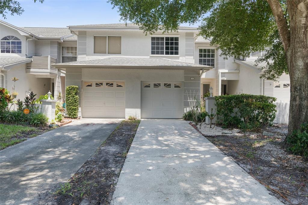 a front view of a house with a yard and a garage