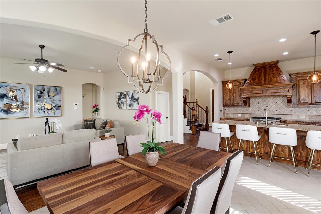 a view of a dining room and livingroom with furniture wooden floor a chandelier