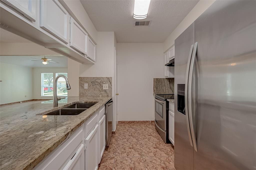 a kitchen with a sink and stainless steel appliances