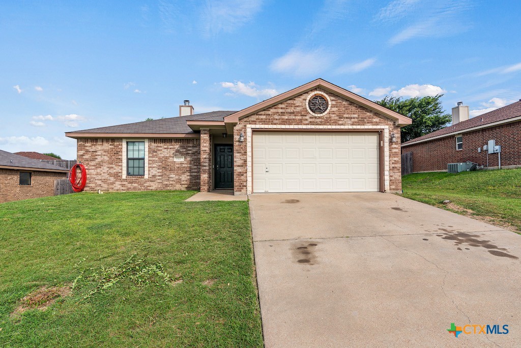 a view of a house with a yard and garage