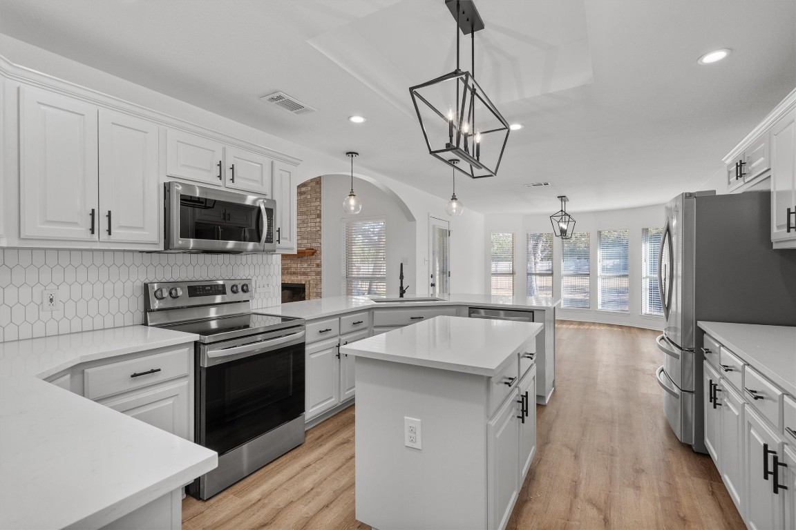 a kitchen with a stove a sink and a refrigerator