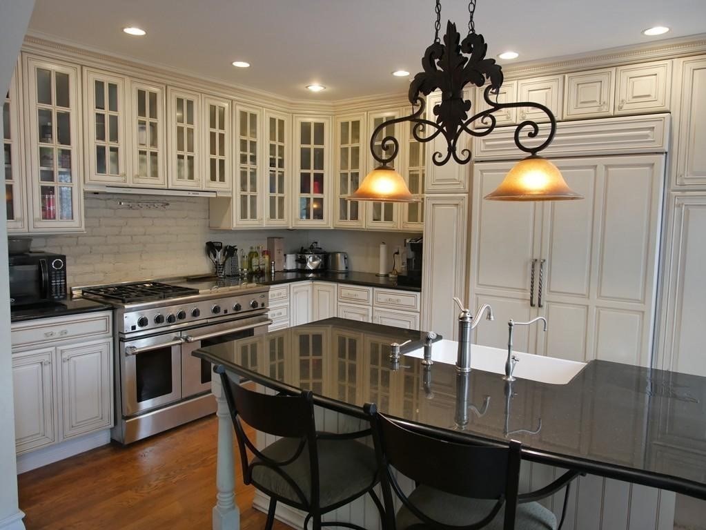 a kitchen with a table chairs and cabinets