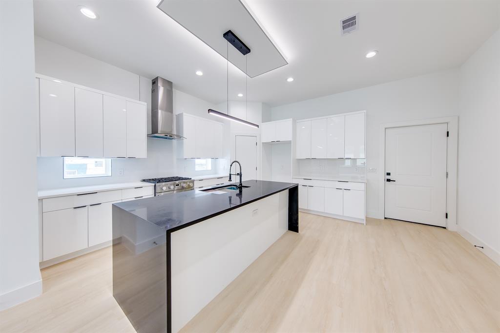 a kitchen with stainless steel appliances granite countertop a sink and cabinets