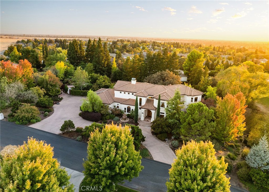 an aerial view of a house with a yard and lake view