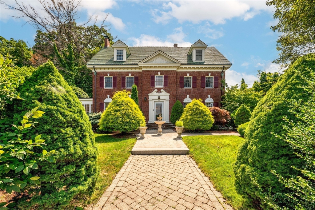 a front view of a house with garden